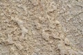 Wall is covered with decorative marble crumbs. White, gray and brown marble blotches of stone on the insulated facade of Royalty Free Stock Photo