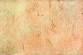 Wall with cracked orange paint. Beautiful background. Texture of old cover with cracks. Royalty Free Stock Photo