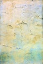 A wall with cracked yellow and blue paint. Beautiful background. Texture of old cover with cracks. Royalty Free Stock Photo