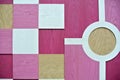 Wall decorated with pink and white wooden geometric designs