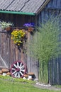 Wall decorations in farm - flowers, stone and carriage wheel