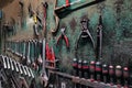 Wall with different metal instruments in little factory room