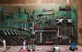 Wall with different metal instruments in little factory room