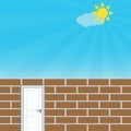 Brick wall with door, blue sky and sun, freedom concept Royalty Free Stock Photo