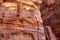 Wall with the door, the entrance to the temple, carved into the red sandstone rock in the canyon. Royalty Free Stock Photo