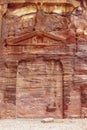 Wall with the door, the entrance to the temple, carved into the red sandstone rock in the canyon. Royalty Free Stock Photo