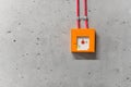 Wall emergency switch. Concrete wall orange box. Fire alarm