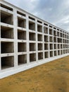 Wall with empty niches for coffins in a cemetery. Row with empty graves for cremation