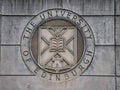 On the wall at the entrance to St Leonard\'s Land in Holyrood Road, the coat of arms of the University of Edinburgh