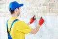 Wall facing work with brick by professional bricklayer worker