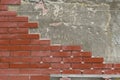 Wall or fence decoration. Laying decorative tiles for red bricks on a vertical surface Royalty Free Stock Photo