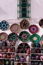 Wall filled with a selection of woven baskets and decorative plates.