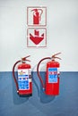 Wall, fire extinguisher and sign for safety, emergency or protection in interior of room. Metal, equipment and tools for