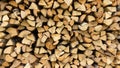 Wall of firewood, Wooden background. Natural texture. Background of dry chopped firewood logs in a pile