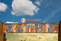 The wall of the former House of Culture of Combine Builders with a mosaic of Soviet times and with the logo and the name of the