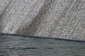 Wall fountain with water flowing down the textured stone surface Royalty Free Stock Photo