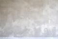 a wall freshly plastered, cement trowel beside it