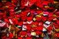 Wall full of red and pink love locks shaped as hearts