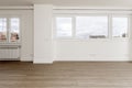 Wall full of windows with views of a living room with wooden floors and plain white painted walls Royalty Free Stock Photo