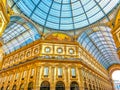 The wall of Galleria Vittorio Emanuele II with boutiques on the ground floor and the large painting under the dome, on April 11 in