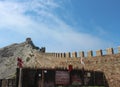 The wall of Genoese Fortress as a part of mountain and entrance to exhibition of torture instruments