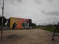 Wall with graffiti art in Max Feffer municipal park, trees, grass, sidewalk. In the city of Suzano