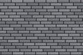 A wall of gray brick and dark cement. Pattern of new brickwork. Royalty Free Stock Photo