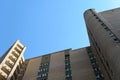 wall of a high residential multi storey brick house against the blue sky