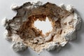 Wall hole damage textured beige white plaster, isolated on a white background Royalty Free Stock Photo