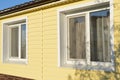 wall of the house coated with yellow siding Royalty Free Stock Photo