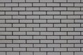 The wall of the house is lined with gray bricks. Used as a background. Royalty Free Stock Photo