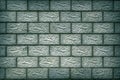 The wall of the house is made of concrete blocks. Aged blue-green tinted background or wallpaper with vignetting. Brickwork