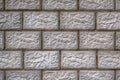 The wall of the house is made of gray concrete blocks. Aged background or wallpaper. The seams form a pattern similar to brickwork Royalty Free Stock Photo