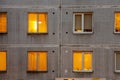 Wall with Iluminated windows of soviet era block apartment building. Royalty Free Stock Photo