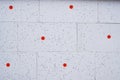 Wall insulation made of pinoplast. Texture with black splashes and red fasteners. Royalty Free Stock Photo