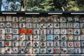 Wall of Japanese wine jars of traditional alcohol brands in Menji with different signs and images