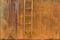 Very Rusty Wall With Pipe Valve and Ladder Royalty Free Stock Photo