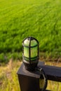 Wall lamp over green field background