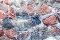 Wall of large boulders covered with ice