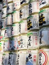 Wall of large sake cans with japanese characters