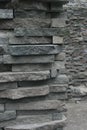 Wall of layered stones in a rough hewn pattern with wall in background showing depth and extent of the wall