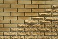 Wall of light smooth and uneven bricks