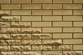 Wall of light smooth and uneven bricks