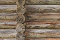 Wall of logs of an old wooden house - architecture background Royalty Free Stock Photo