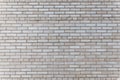 The wall is made of gray silicate bricks. Brickwork on the construction site of the house. Abstract construction texture