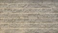 The wall is made of gray stone shabby brick. Brick dilapidated textured masonry