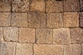 A wall made of irregular yellow volcano stone cubes - angkor wat