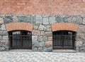 Texture of a wall made of large granite stones and red bricks Royalty Free Stock Photo