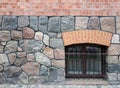 Texture of a wall made of large granite stones and red bricks Royalty Free Stock Photo