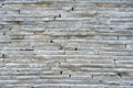 The wall is made of light marble, marble bricks lying on top of each other